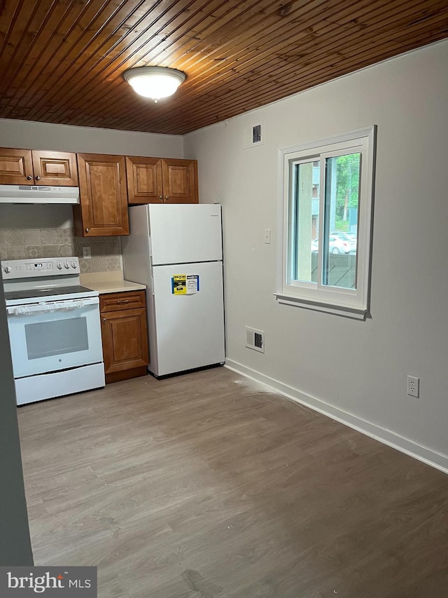 kitchen featuring decorative backsplash, white appliances, light hardwood / wood-style flooring, and wooden ceiling