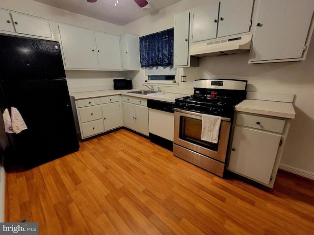 kitchen with sink, stainless steel gas range oven, black fridge, white dishwasher, and white cabinets