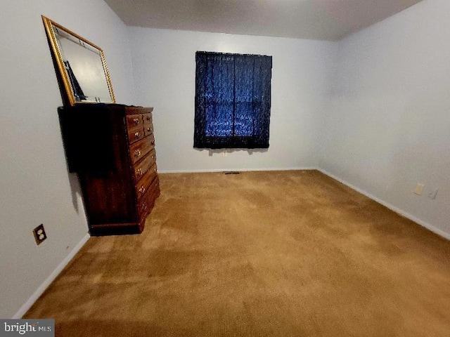 unfurnished bedroom with light colored carpet