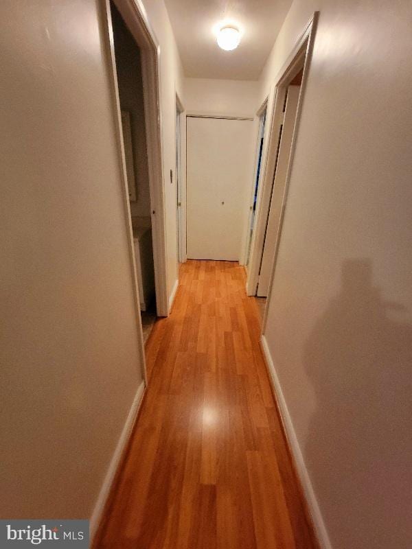 corridor with light hardwood / wood-style floors