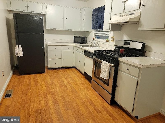 kitchen with white cabinetry, sink, black appliances, and light hardwood / wood-style flooring