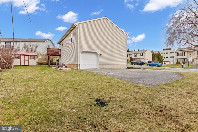 1025 Harmony Hl, Lebanon, PA 17046 - view of side of property featuring an outbuilding, a garage, a storage shed, a lawn, and a residential view