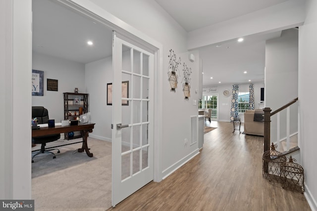 hall featuring french doors and light wood-type flooring