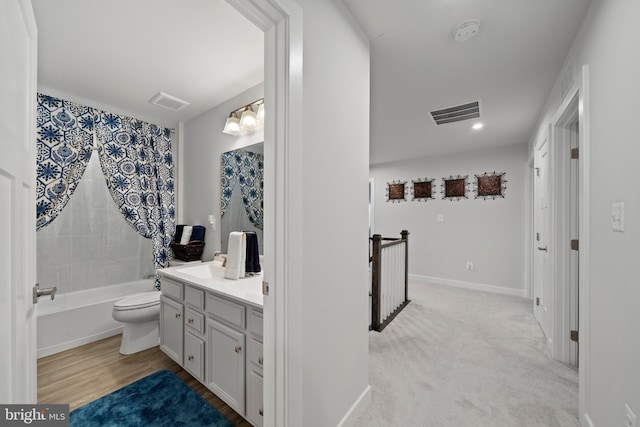 full bathroom with toilet, vanity, and shower / tub combination