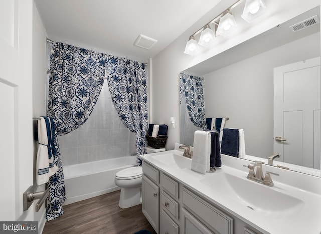 full bathroom with toilet, vanity, shower / bath combination with curtain, and hardwood / wood-style floors