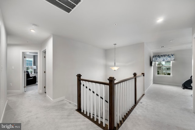 corridor with light colored carpet