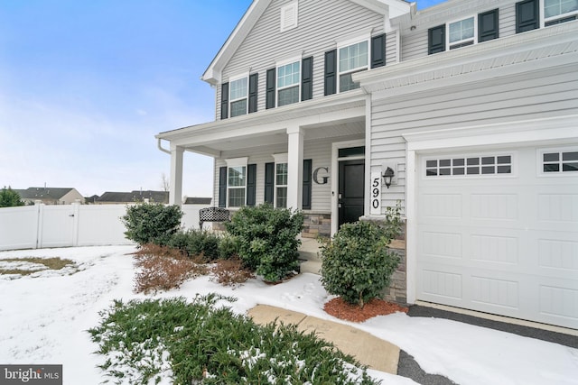 view of front facade with a garage and a porch