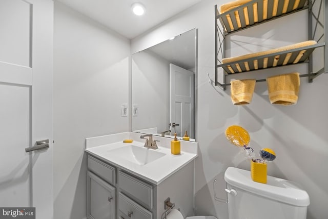 bathroom with toilet and vanity