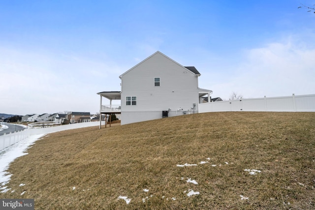 rear view of property with a yard