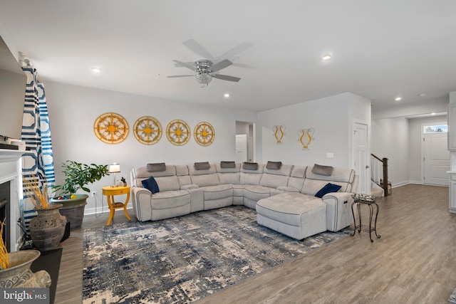 living room featuring ceiling fan and wood-type flooring