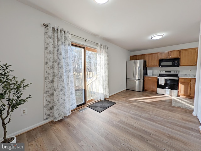 kitchen featuring stainless steel appliances and light hardwood / wood-style floors