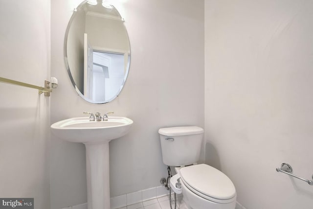 bathroom with tile patterned flooring, sink, and toilet