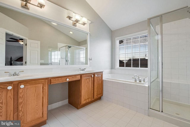 bathroom featuring tile patterned floors, lofted ceiling, separate shower and tub, vanity, and ceiling fan