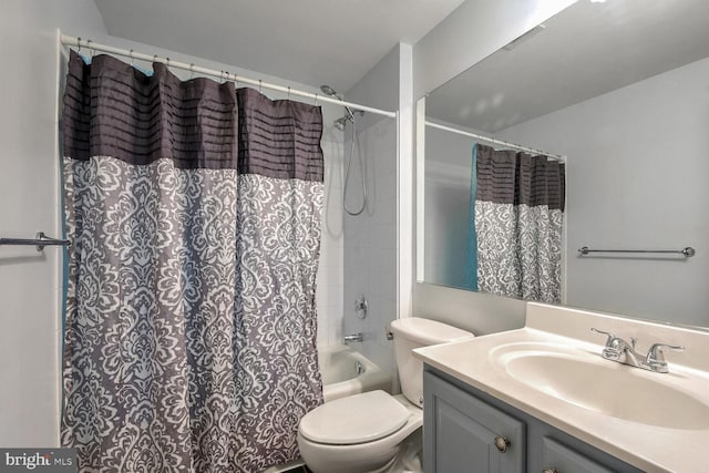 full bathroom with vanity, shower / bath combination with curtain, and toilet