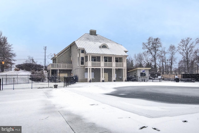 view of snow covered rear of property