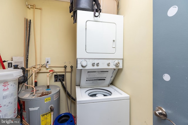 laundry area featuring electric water heater and stacked washer / drying machine