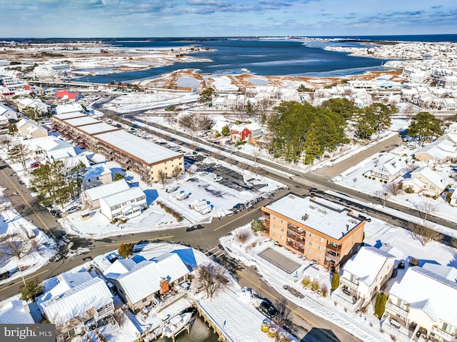 snowy aerial view featuring a water view