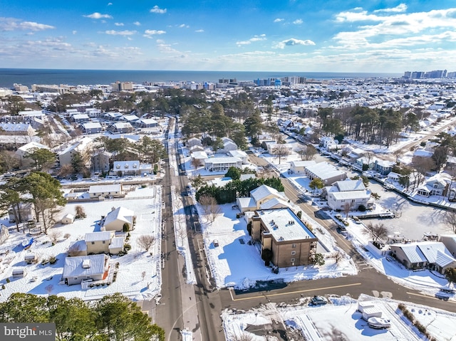 snowy aerial view with a water view