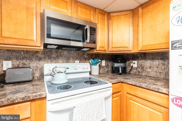 kitchen with backsplash and electric stove