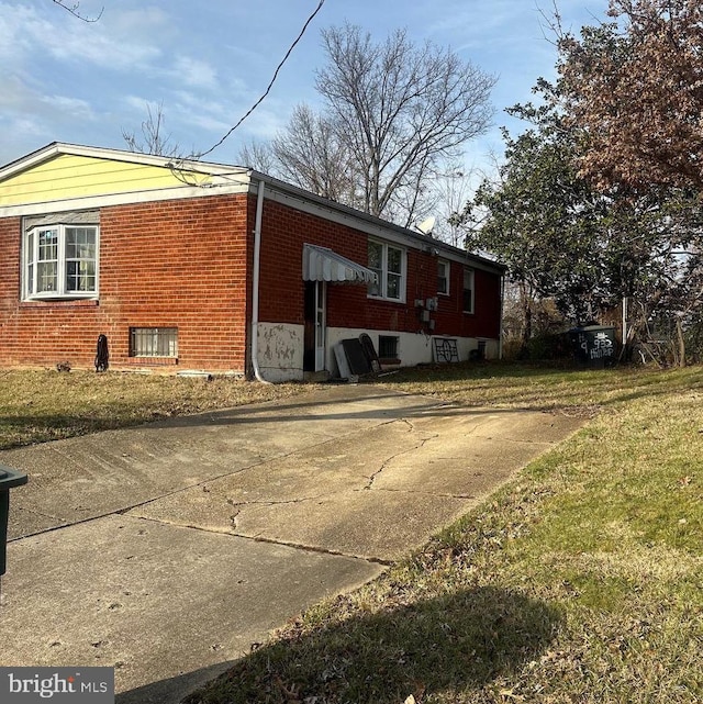 view of side of property with a lawn