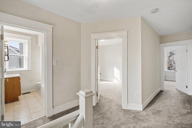 corridor with light colored carpet