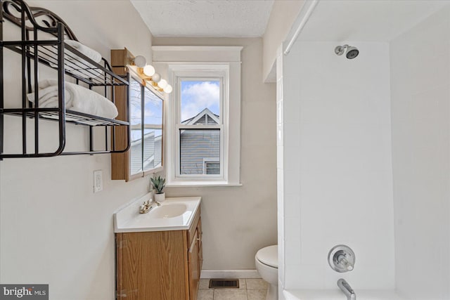 full bathroom featuring tile patterned floors, vanity, a textured ceiling, shower / bathing tub combination, and toilet