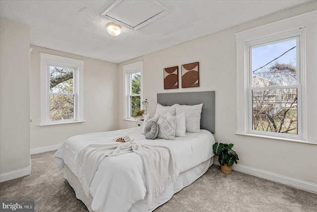 bedroom with carpet floors and a textured ceiling