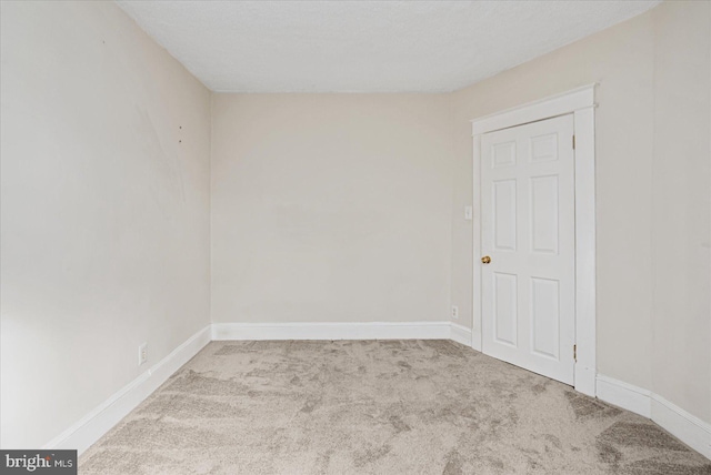 unfurnished room featuring light colored carpet