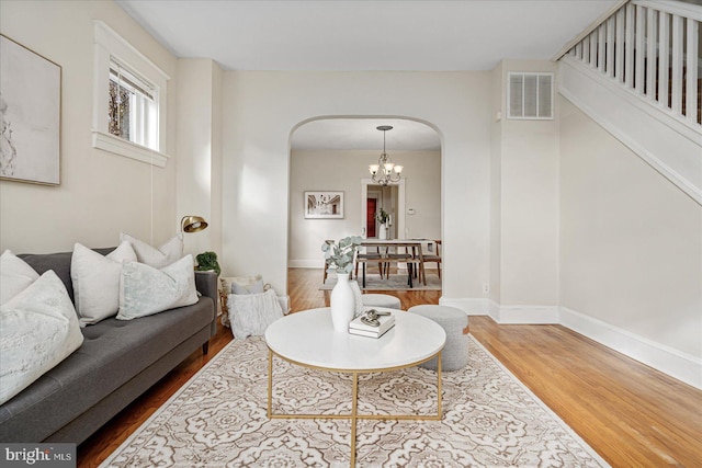 living room with a chandelier and wood-type flooring