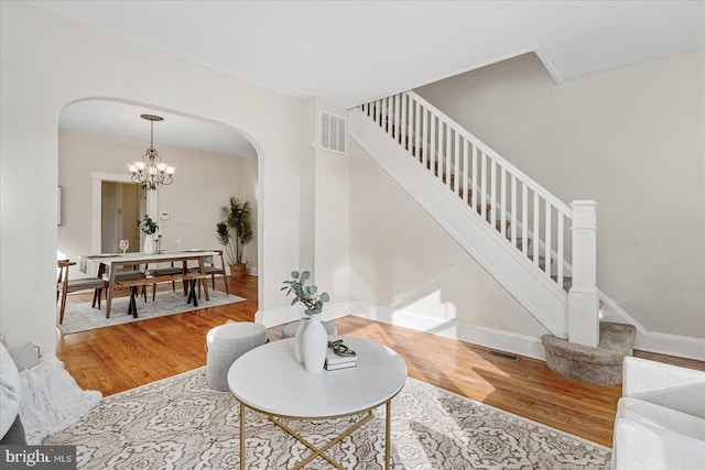 interior space featuring hardwood / wood-style flooring and a notable chandelier