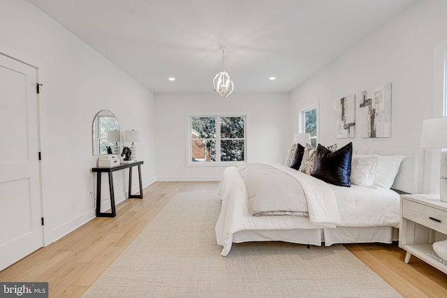 bedroom featuring multiple windows and light hardwood / wood-style flooring