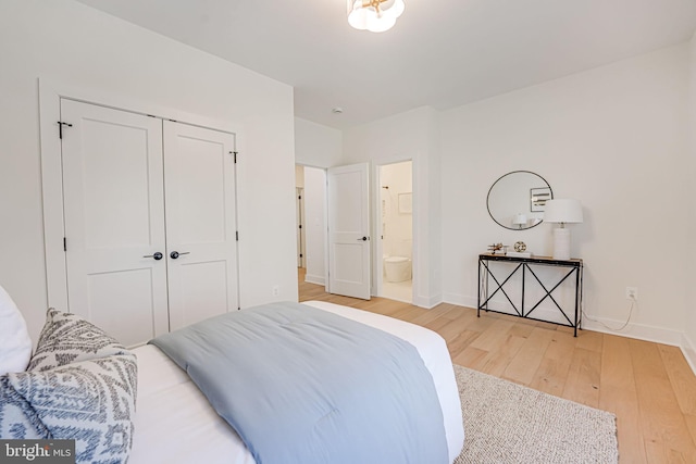 bedroom featuring hardwood / wood-style floors, a closet, and ensuite bathroom