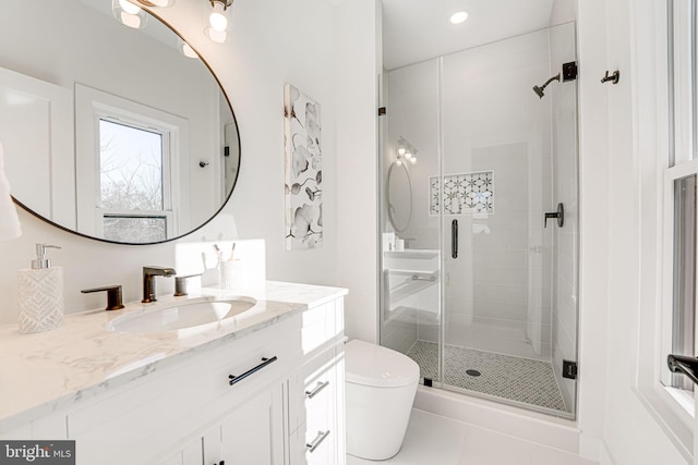 bathroom featuring an enclosed shower, vanity, tile patterned flooring, and toilet