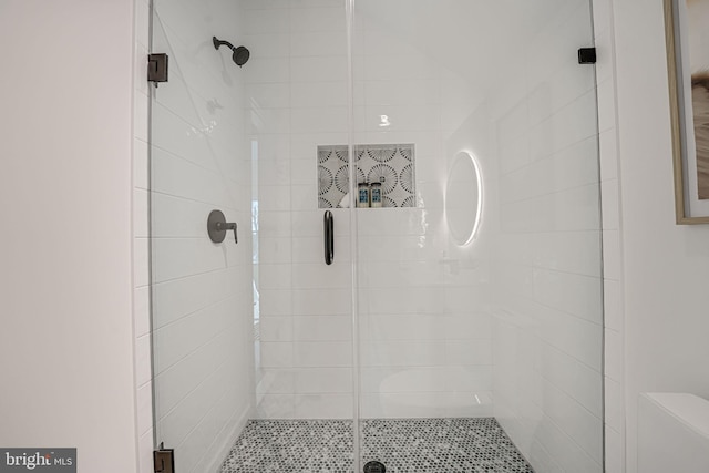 bathroom with a shower with door