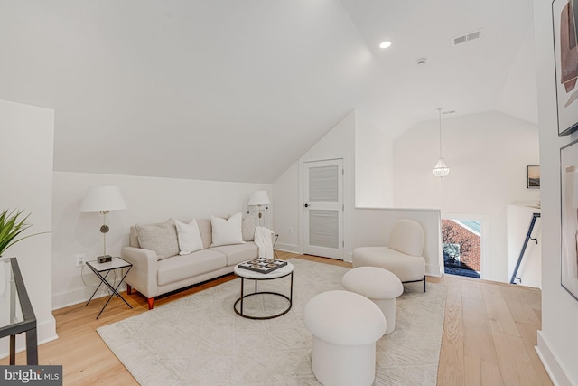 living room with hardwood / wood-style flooring and lofted ceiling