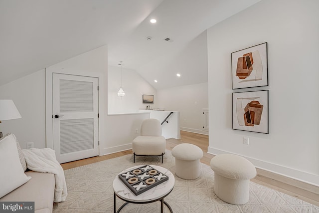 sitting room with lofted ceiling and light hardwood / wood-style flooring