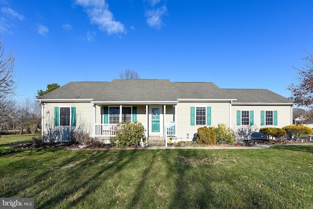 ranch-style house featuring a porch and a front yard