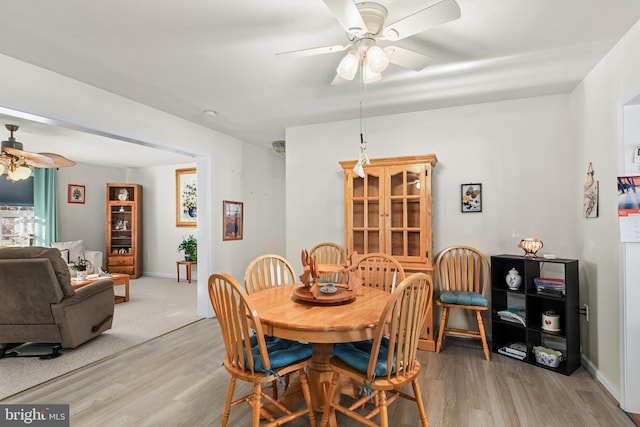 dining area with ceiling fan and light hardwood / wood-style flooring