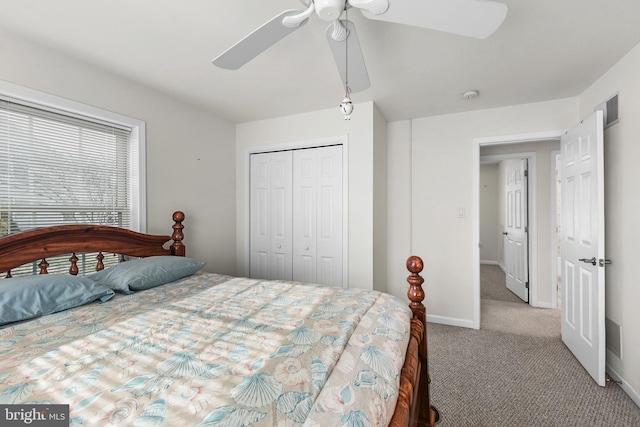 bedroom featuring ceiling fan, a closet, and light carpet