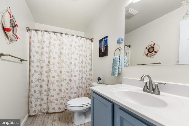 bathroom featuring hardwood / wood-style floors, vanity, and toilet