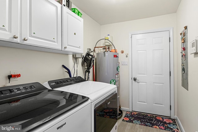 washroom featuring cabinets, light hardwood / wood-style floors, washer and clothes dryer, and gas water heater