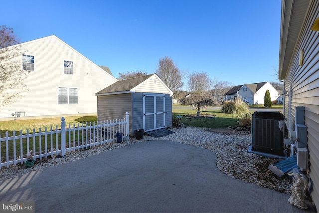 view of patio / terrace with central AC and a shed