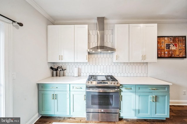 kitchen with tasteful backsplash, white cabinets, wall chimney range hood, and stainless steel range with gas stovetop