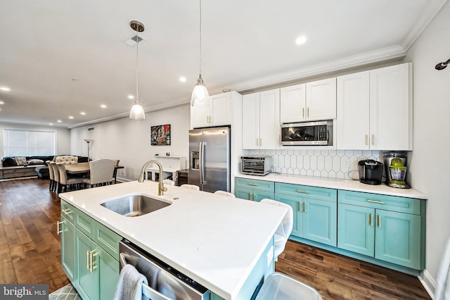 kitchen featuring sink, pendant lighting, a center island with sink, white cabinets, and appliances with stainless steel finishes