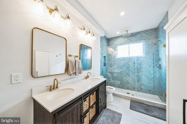 bathroom with vanity, a shower with shower door, and toilet