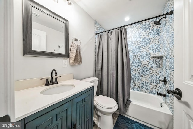 full bathroom featuring shower / bath combo, vanity, and toilet