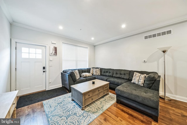 living room with crown molding and dark wood-type flooring