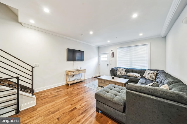 living room featuring ornamental molding and light wood-type flooring