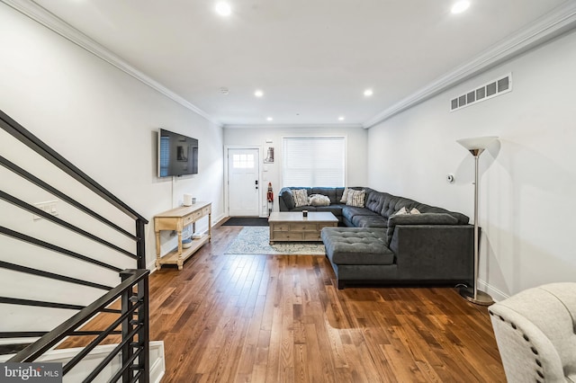 living room with dark hardwood / wood-style floors and ornamental molding