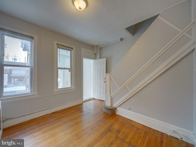 unfurnished room with hardwood / wood-style flooring